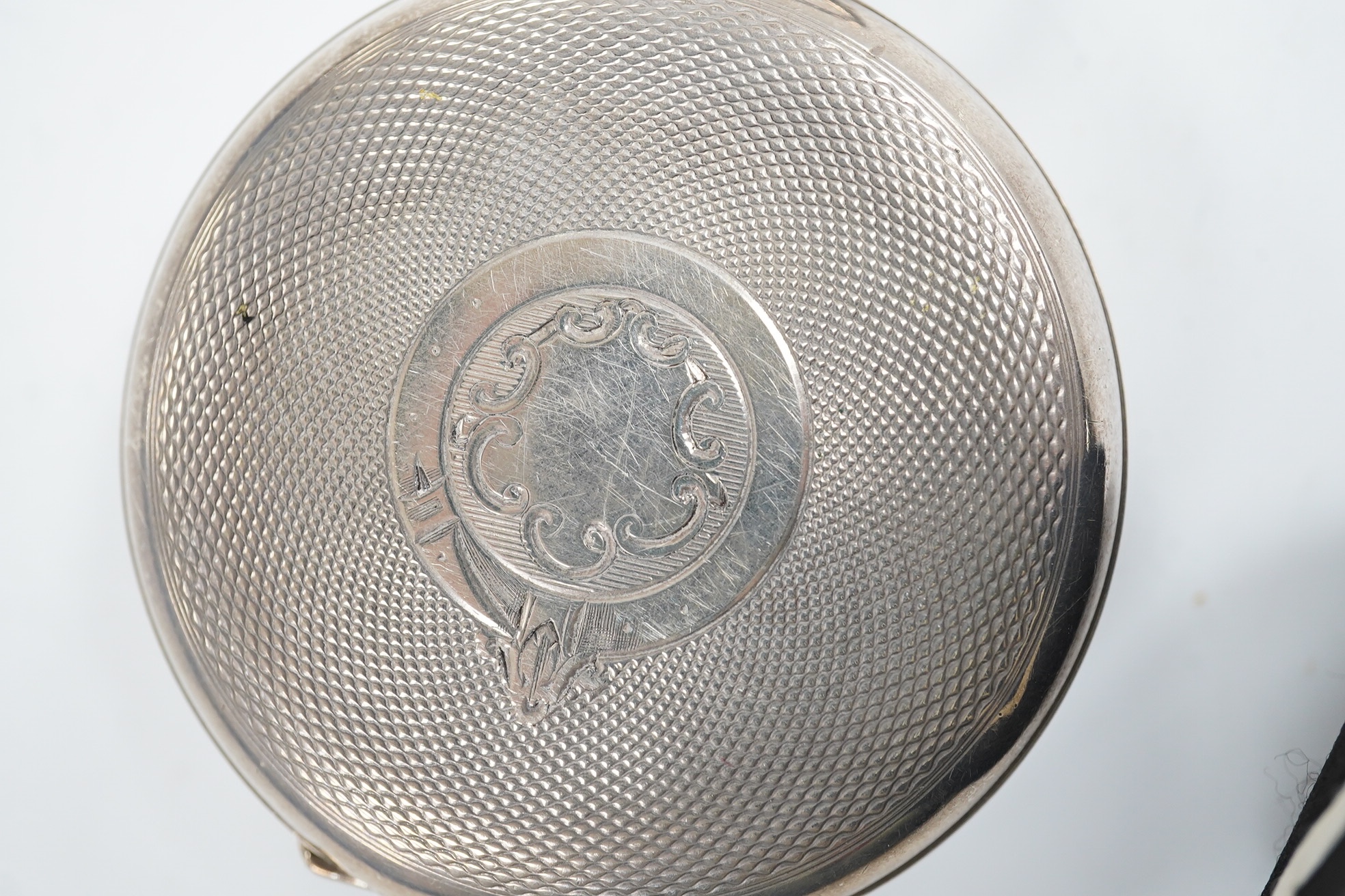 A late 19th century engine turned Swiss 935 standard white metal key wind open faced pocket watch, with engraved inscription relating to J.B. Dent & Sons, London, case diameter 53mm. Condition - fair